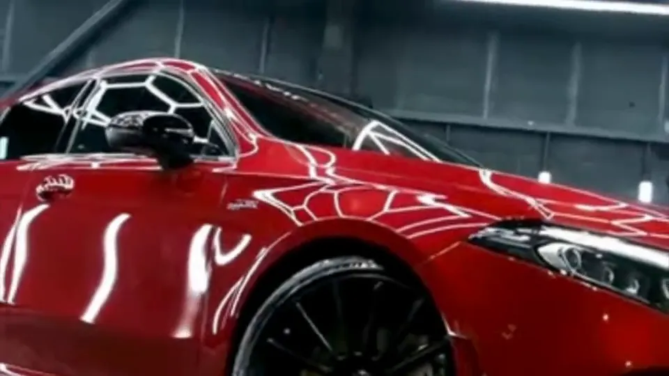 Red Mercedes-AMG A-Class under the hexagon lights during a ceramic coating at The Detail Devils
