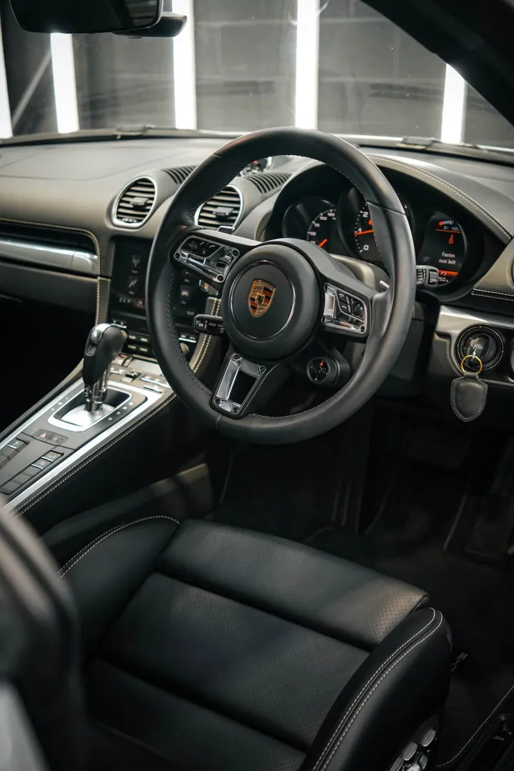 Porsche 718 driver's seat and steering wheel after interior detail
